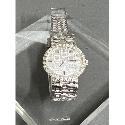 513A - A Ladies 18ct gold and diamond Omega watch, textured white dial, black hourly makers, a 17 jewel man... 