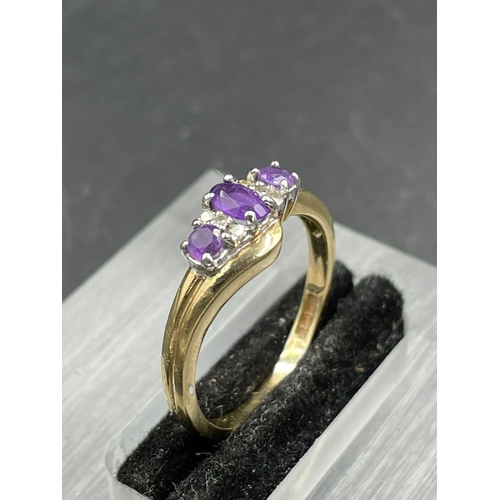 472A - An amethyst and diamond ring, central oval cut amethyst weighing an estimated 0.16ct with three sing... 