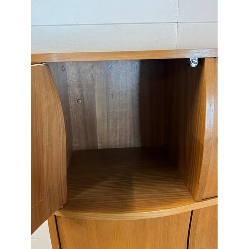 1 - A contemporary wave front cabinet with eight compartments on chrome legs (74cm x 38cm x 155cm)