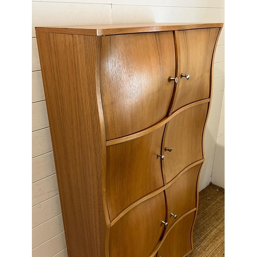 1 - A contemporary wave front cabinet with eight compartments on chrome legs (74cm x 38cm x 155cm)