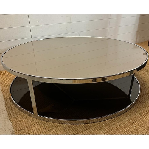 10 - An Italian contemporary circular smoked glass coffee table on chrome frame by Minotti (H34cm D120cm)