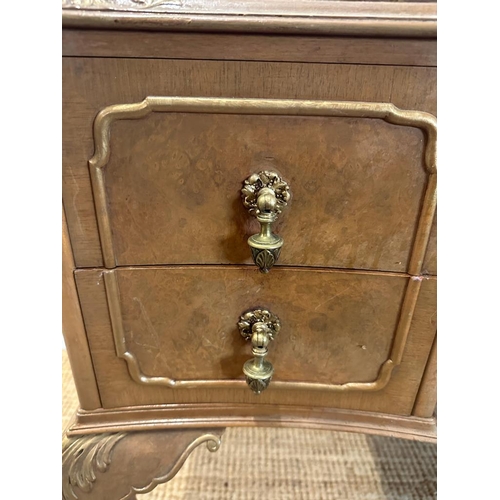 104 - A bow fronted dressing table with galleried top and brass drop handles on cabriole legs (H84cm W130c... 