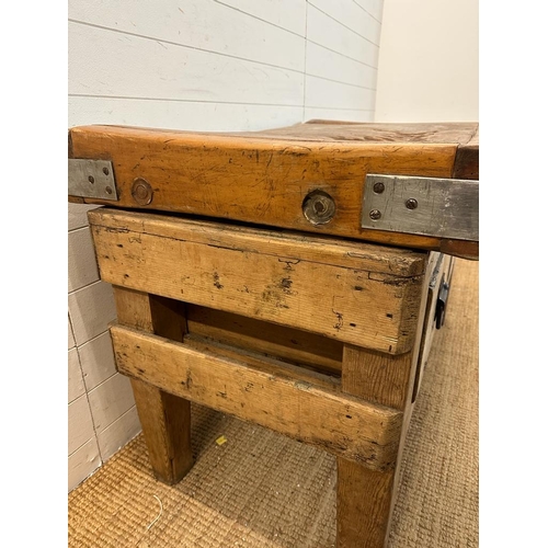 120 - A large reclaimed butchers block on a pine two drawer stand (H70cm W122cm D69cm)