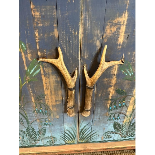 121 - A pine painted cupboard with horn handles and floral motif (top missing) (H81cm W85cm D55cm)