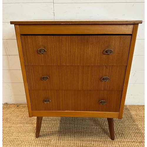 124 - A mid century three drawer chest of drawers on splayed legs. Height 75 44x60