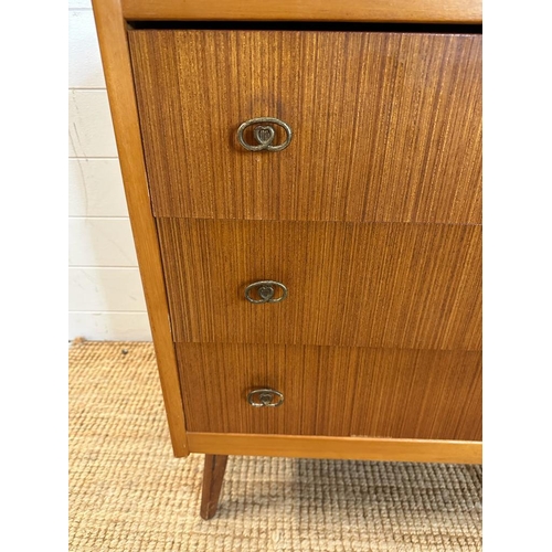 124 - A mid century three drawer chest of drawers on splayed legs. Height 75 44x60