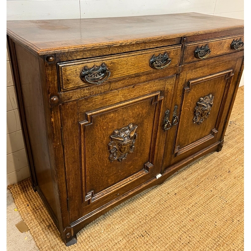 130 - Oak sideboard with carved crest detail to front (H90cm W130cm D50cm)