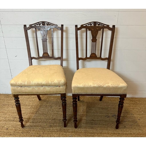 131 - Two Edwardian hall chairs with inlaid backs and turned legs