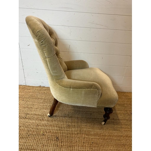 143 - A Victorian button back nursing chair upholstered in a pale green velvet