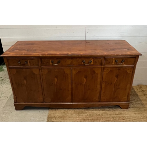 169 - A yew sideboard with double doors opening to shelves flanked by cupboards and drawers above (H80cm W... 