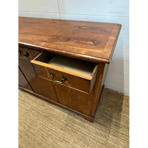 169 - A yew sideboard with double doors opening to shelves flanked by cupboards and drawers above (H80cm W... 