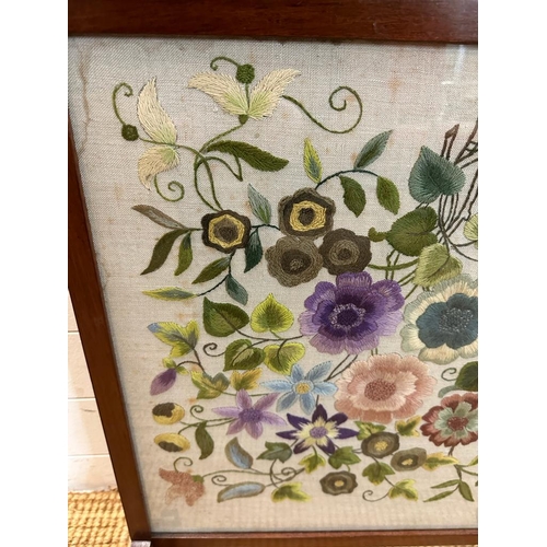 181 - A glass fronted mahogany fire screen with a floral tapestry insert