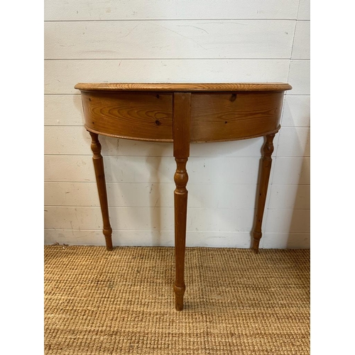 182 - A pine demi lune side table on turned legs (H78cm W78cm D60cm)