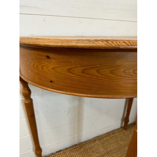 182 - A pine demi lune side table on turned legs (H78cm W78cm D60cm)