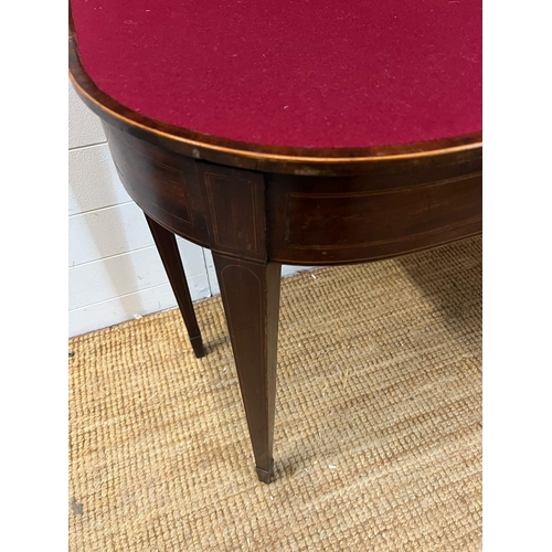 184 - A mahogany folding card table with string inlay and tapering legs (H76cm W94cm D46cm)