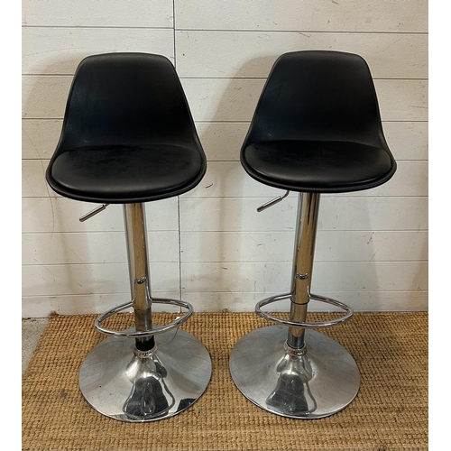 203 - A pair of chrome based faux black leather bar stools