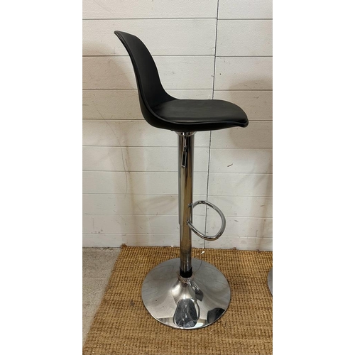 203 - A pair of chrome based faux black leather bar stools