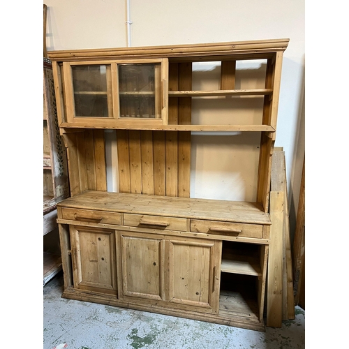 209 - A pine dresser with sliding glazed doors to top, plate rack and sliding doors to base (H202cm W167cm... 