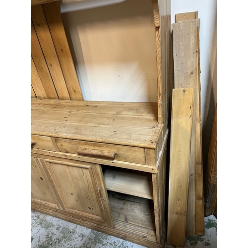 209 - A pine dresser with sliding glazed doors to top, plate rack and sliding doors to base (H202cm W167cm... 