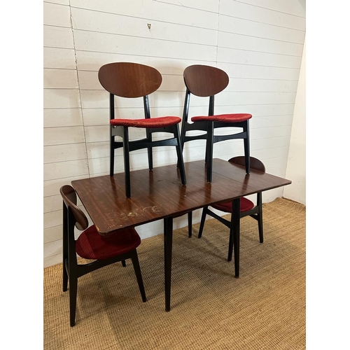 211 - A mid century drop leaf dining table and four ebonised red upholstered dining chairs. Length 140 wid... 