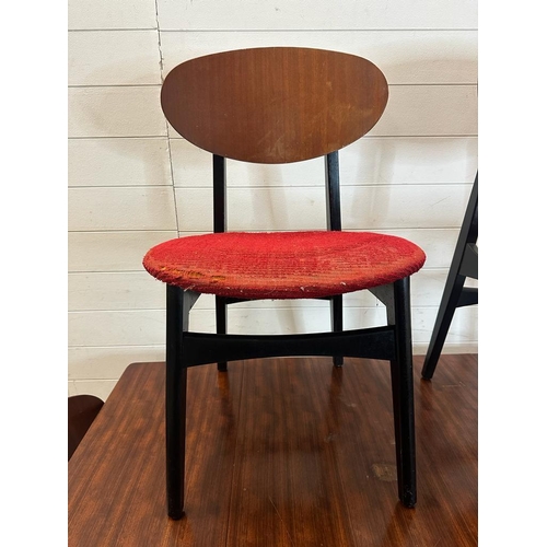 211 - A mid century drop leaf dining table and four ebonised red upholstered dining chairs. Length 140 wid... 