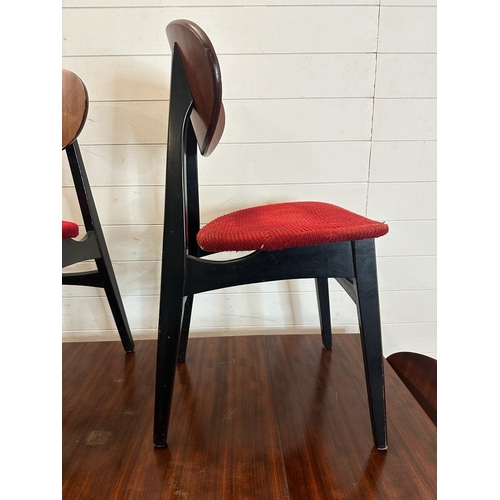 211 - A mid century drop leaf dining table and four ebonised red upholstered dining chairs. Length 140 wid... 