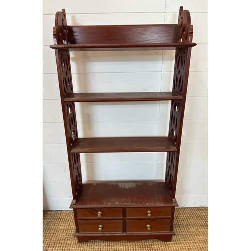 216 - A mahogany four drawer bookcase or wall rack with carved supports