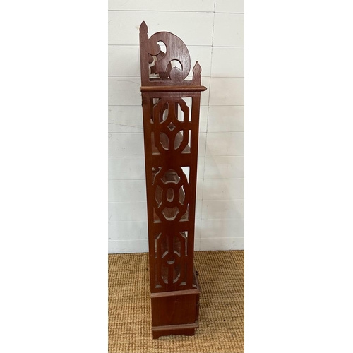 216 - A mahogany four drawer bookcase or wall rack with carved supports