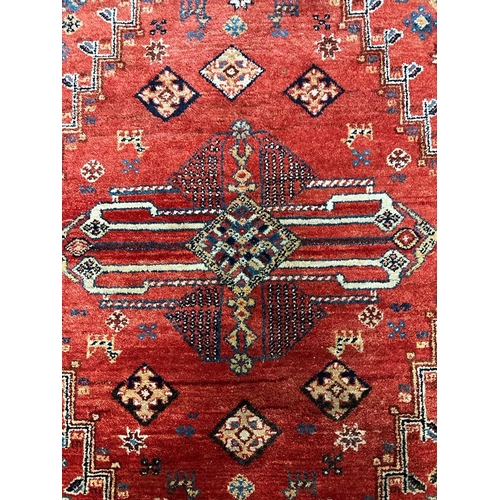 220 - A red ground Keshan Shirvaz style rug 210cm x 148cm