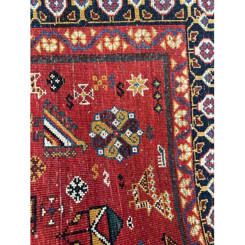 220 - A red ground Keshan Shirvaz style rug 210cm x 148cm