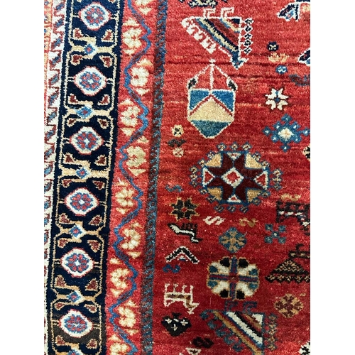 220 - A red ground Keshan Shirvaz style rug 210cm x 148cm