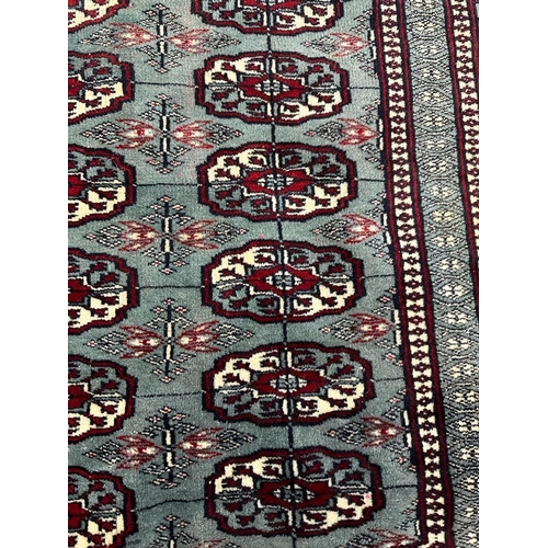 222 - A blue ground wool rug with geometric red and white boarder and geometric central pattern