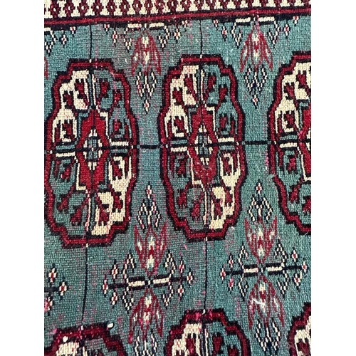 222 - A blue ground wool rug with geometric red and white boarder and geometric central pattern