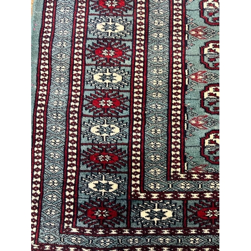 222 - A blue ground wool rug with geometric red and white boarder and geometric central pattern