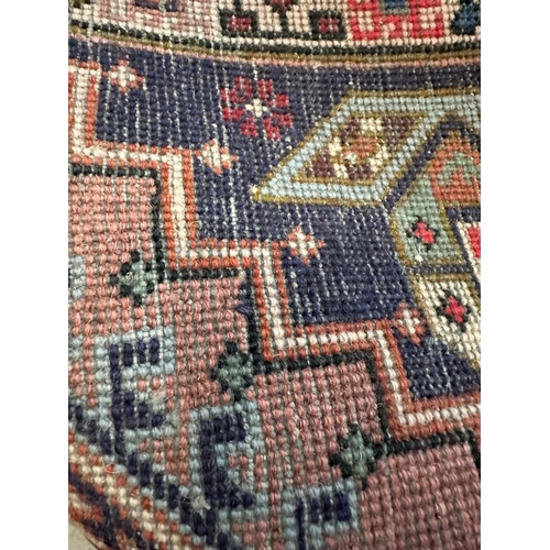 223 - A beige ground wool runner with geometric boarder and Aztec style central 75cm x 309cm