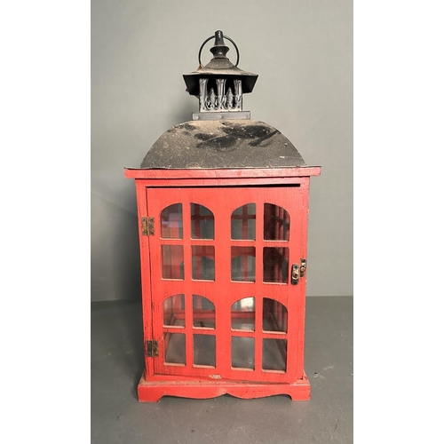 235 - A rustic red painted wooden hanging lantern with glass panels (H51cm)