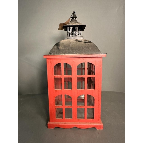 235 - A rustic red painted wooden hanging lantern with glass panels (H51cm)