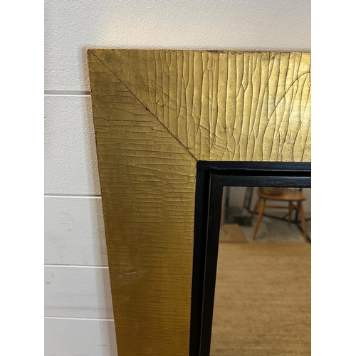 245 - A large mirror with black/gold frame 107 x 130cm