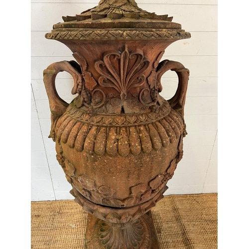 259 - A terracotta stone garden urn of amphora form and scrolling handles (H160cm W66cm)