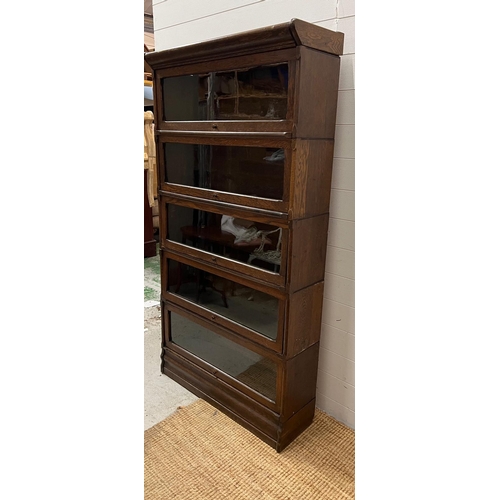 26 - A five tier Casler oak and glazed,barristers bookcase (H166cm W87cm D30cm)