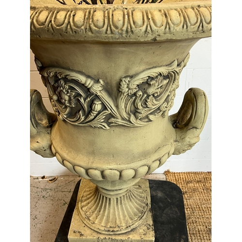 263 - A garden urn planter with scrolling leaves and handles to side on a fluted stem to base (H82cm Dia63... 