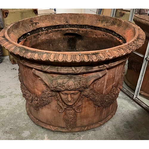 266 - A pair of ornamental terracotta urns with classical style, decorated with a floral laurel joined by ... 