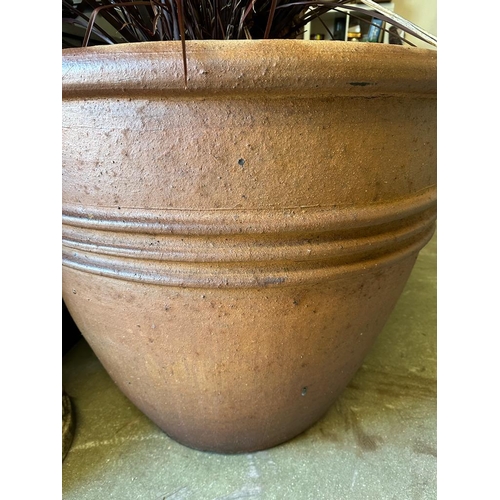 284 - A pair of large terracotta garden planters with ribbed centres (H80cm Dia90cm)