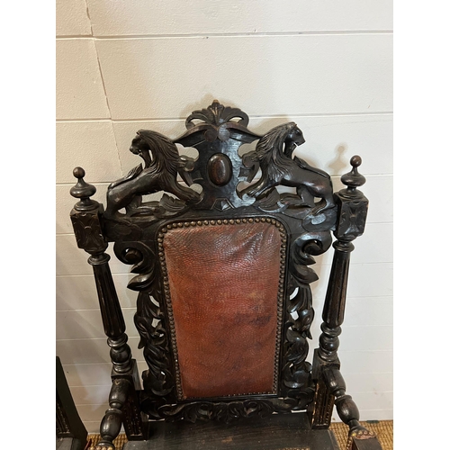 293 - A pair of oak throne chairs, gothic hall chairs with carved swags and scrolls, flanked by tapering c... 