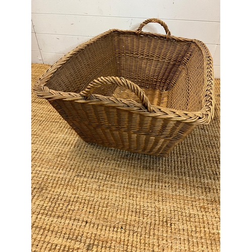 298 - A large wicker laundry basket (H31cm W80cm D56cm)