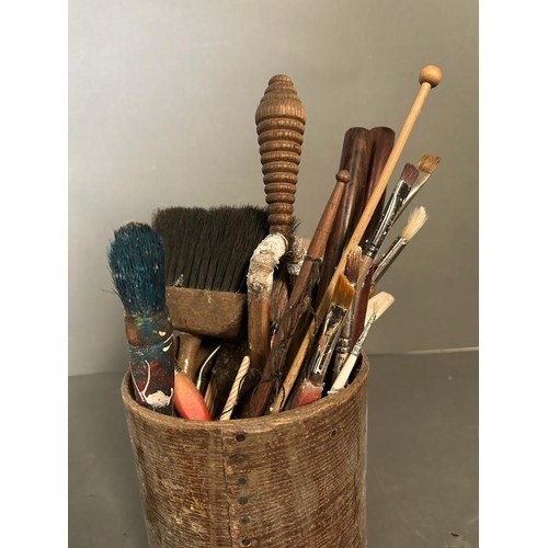 310 - Three wooden pots containing a selection of vintage paint brushes