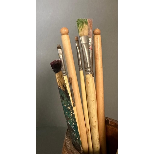 310 - Three wooden pots containing a selection of vintage paint brushes