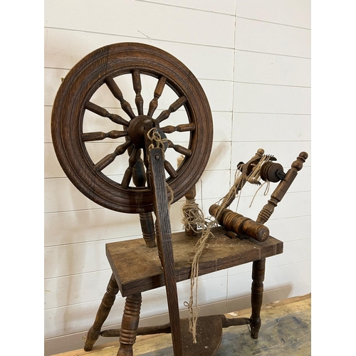 316 - A wooden spinning wheel on turned legs