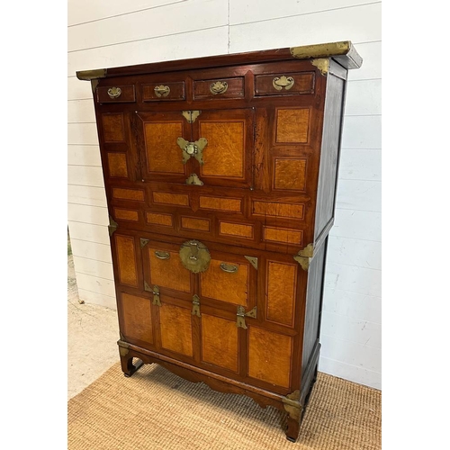 32 - A Korean two toned cabinet comprising of two cupboards with four drawers over, brass hinges, handles... 