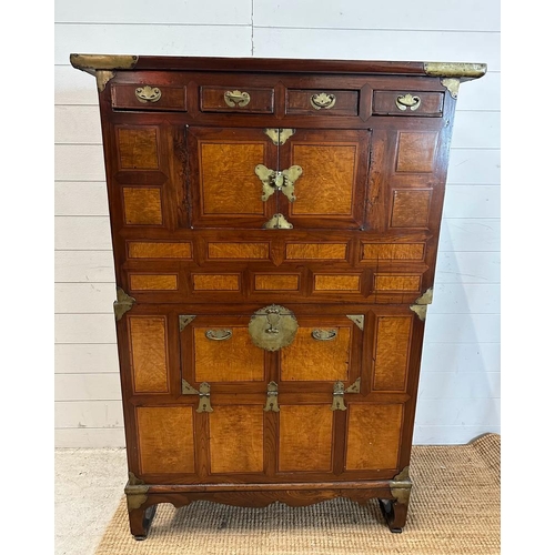 32 - A Korean two toned cabinet comprising of two cupboards with four drawers over, brass hinges, handles... 